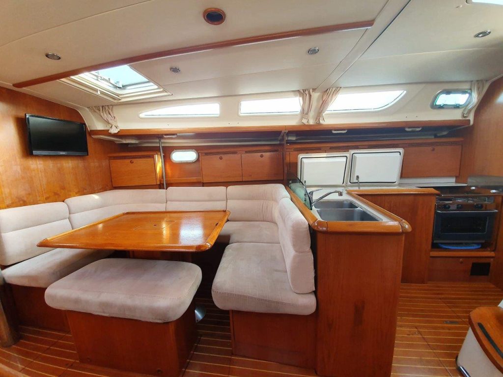 Saloon table in Jeanneau Sun Odyssey 43 Mantiz for charter in Izola in Slovenia